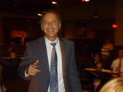 Dr. Dan Greenstein, healthcare comedian, smiling and pointing at the audience